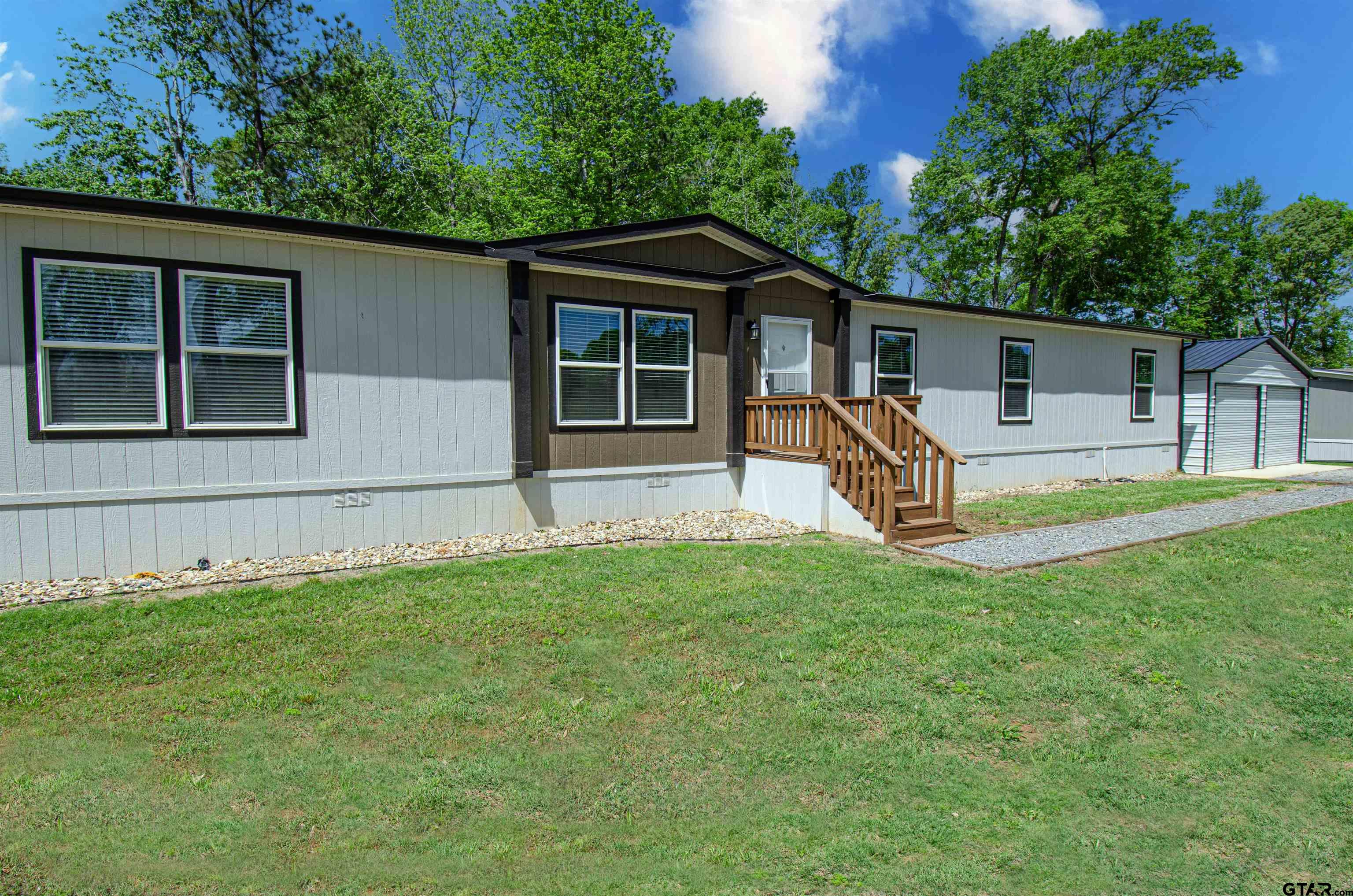 a view of a house with a backyard