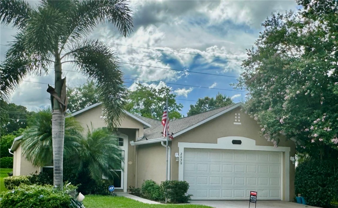 a view of house with a tree