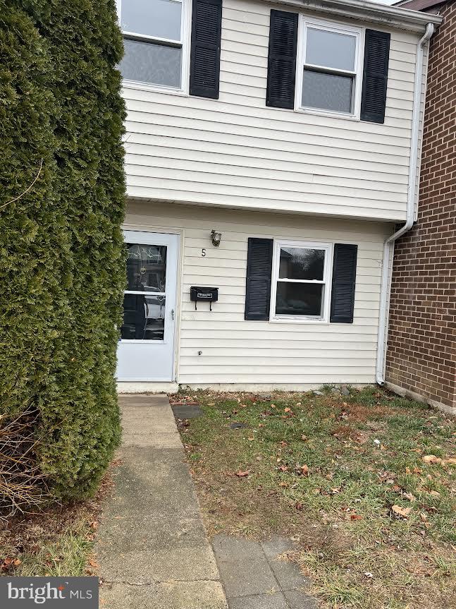 a view of a house with more windows and brick walls