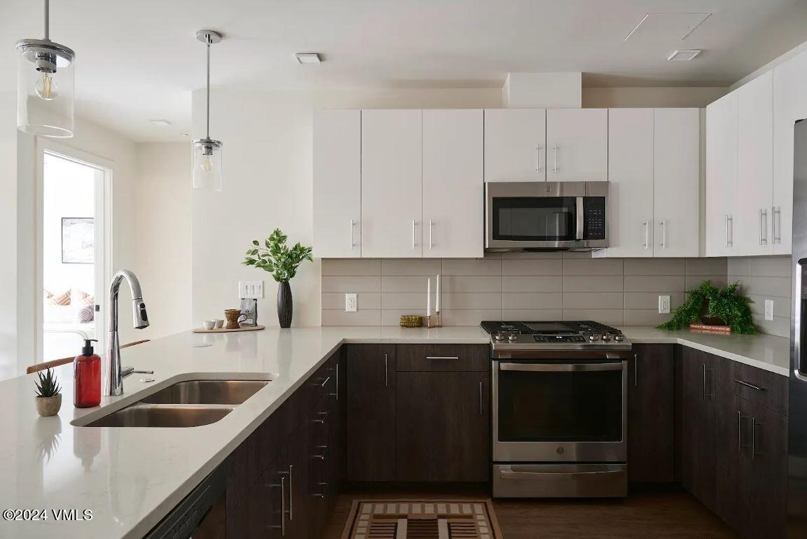 a kitchen with a sink stove and microwave