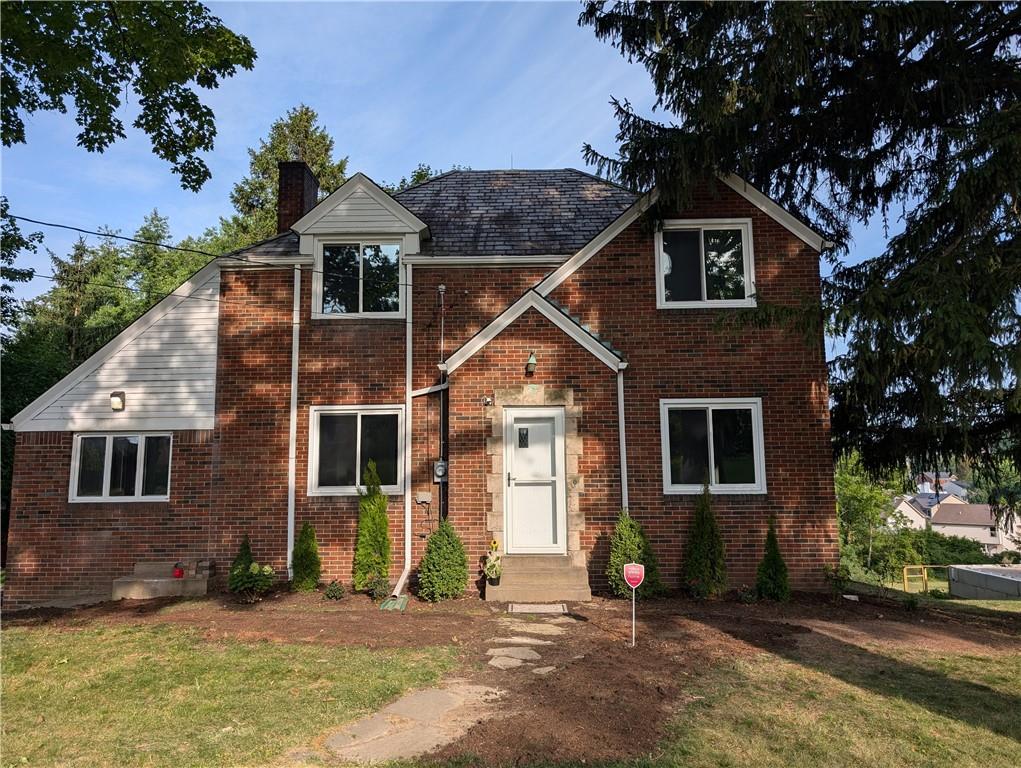 a front view of a house with a yard