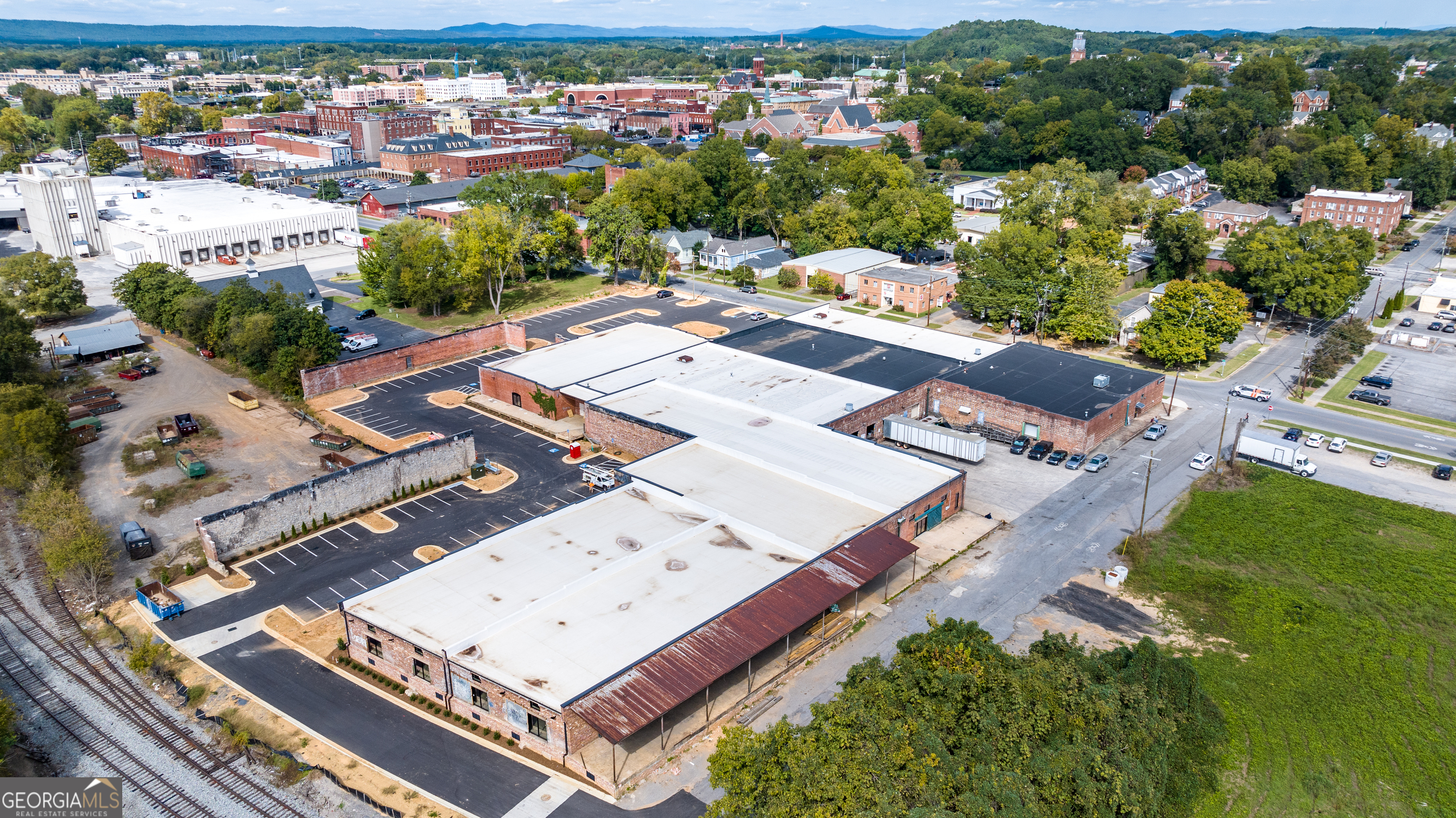 an aerial view of a residential apartment building with a yard