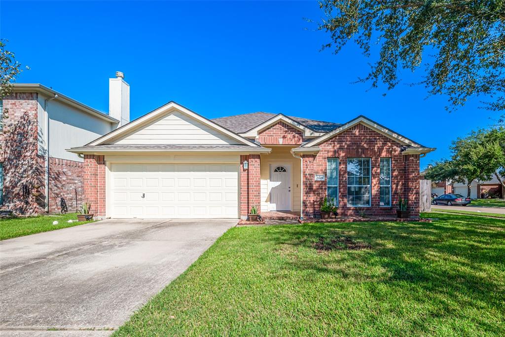 Brick front with double driveway to attached garage