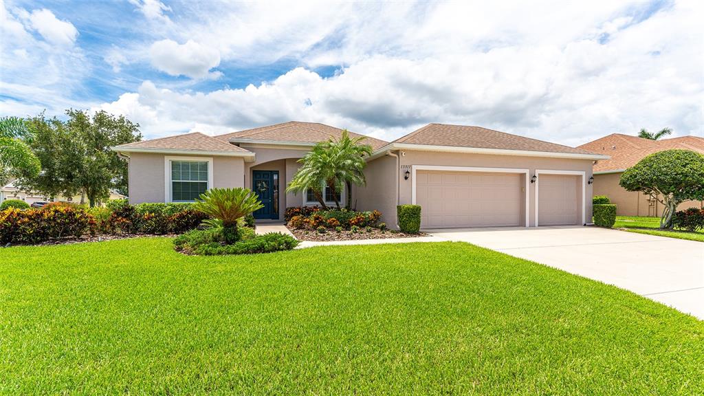 a front view of a house with a yard and garage