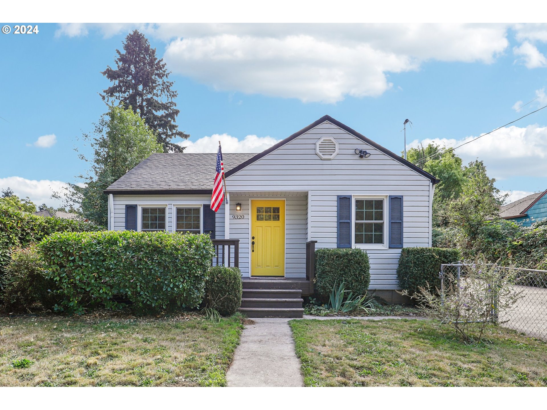 a front view of a house with garden