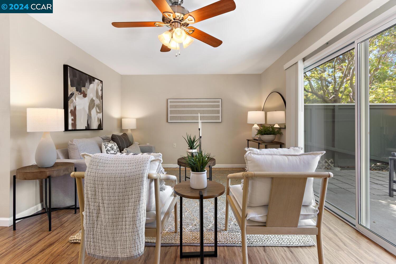 a dining room with furniture a window and wooden floor