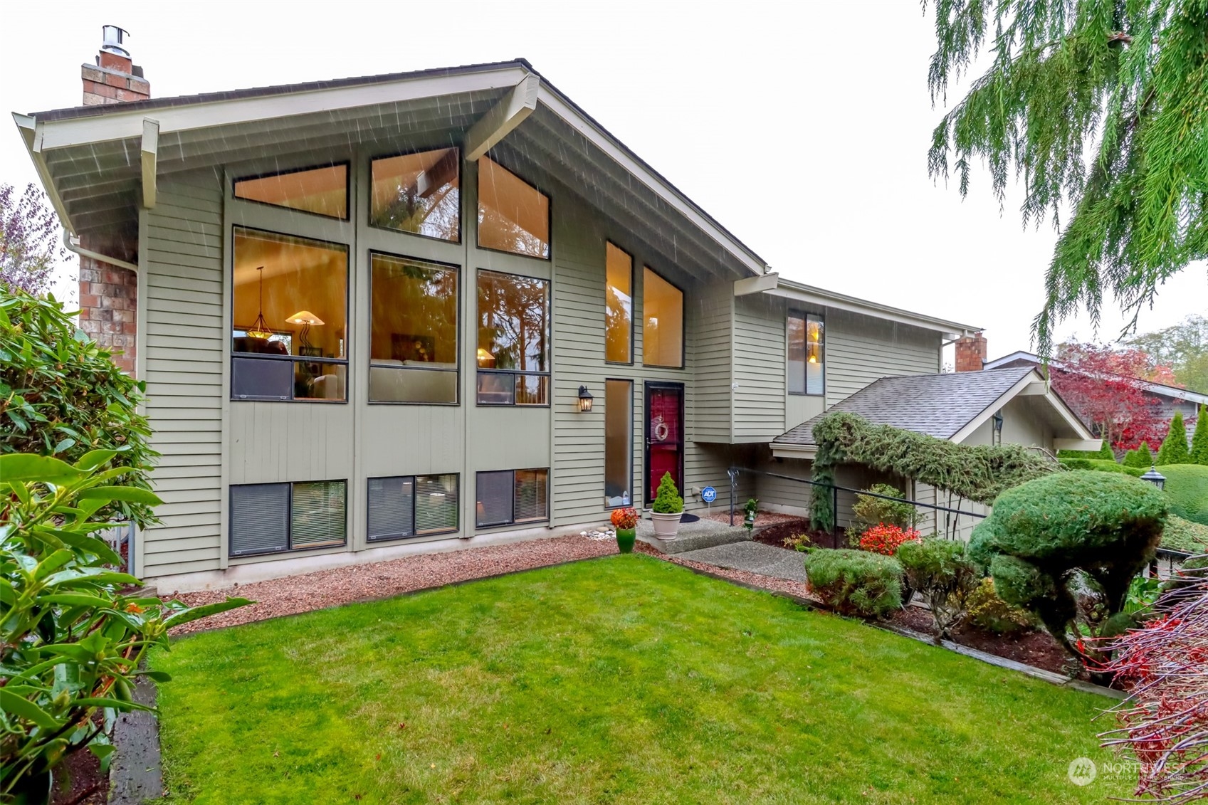 a front view of house with yard and outdoor seating