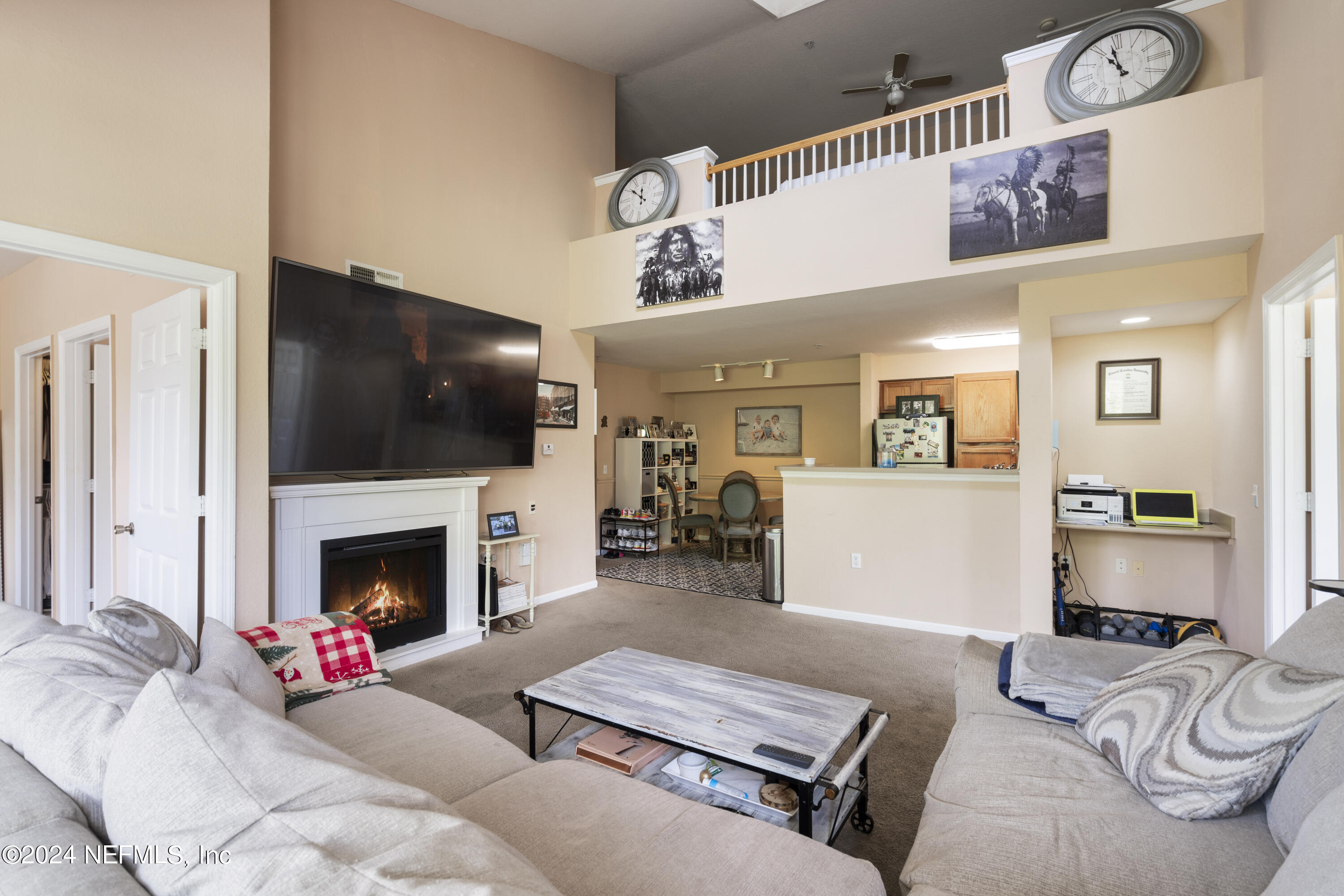 a living room with furniture flat screen tv and a fireplace