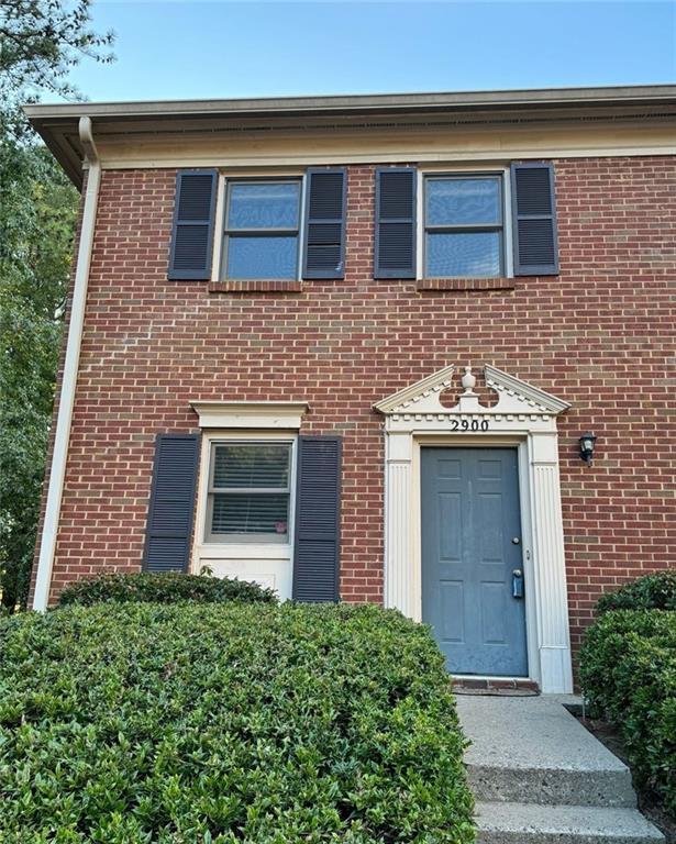 front view of a brick house with a large windows