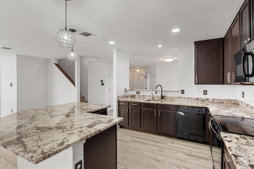 a kitchen with a sink and stove