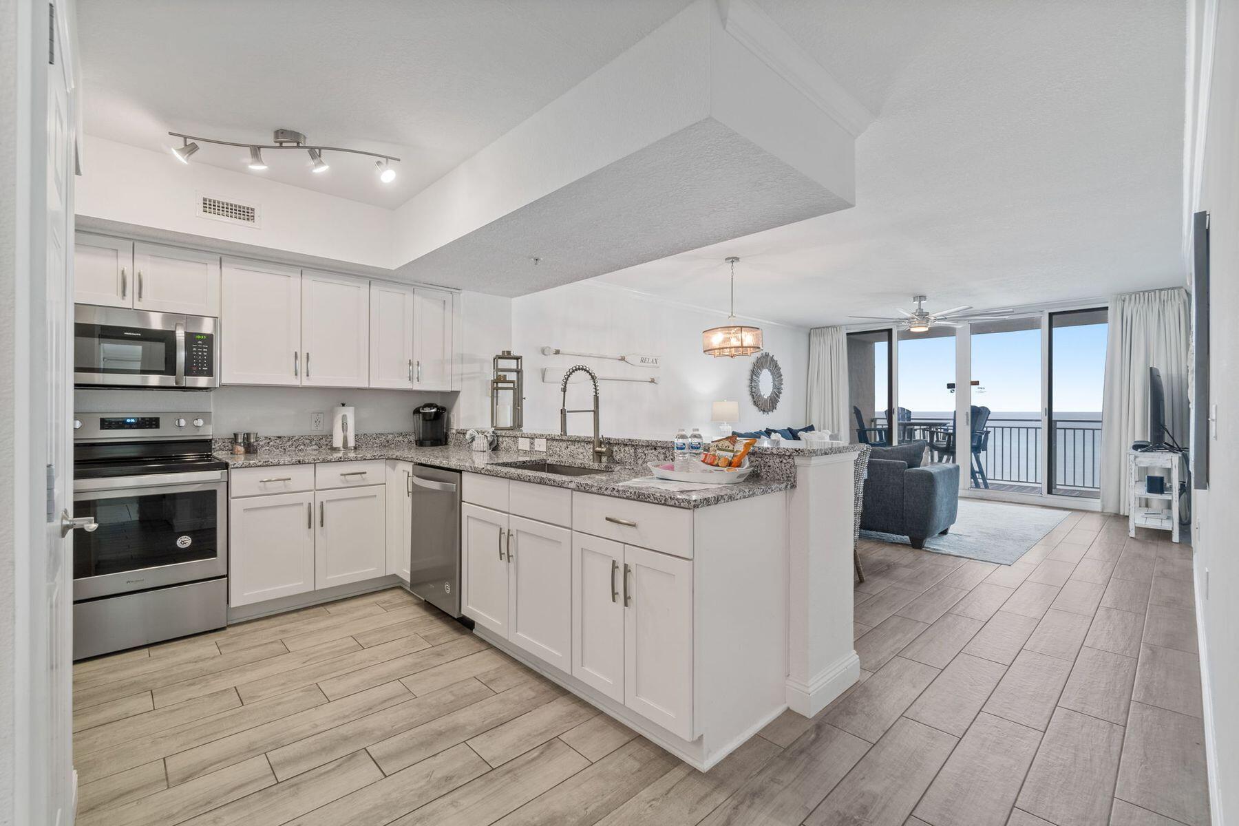 a kitchen with sink cabinets and stainless steel appliances