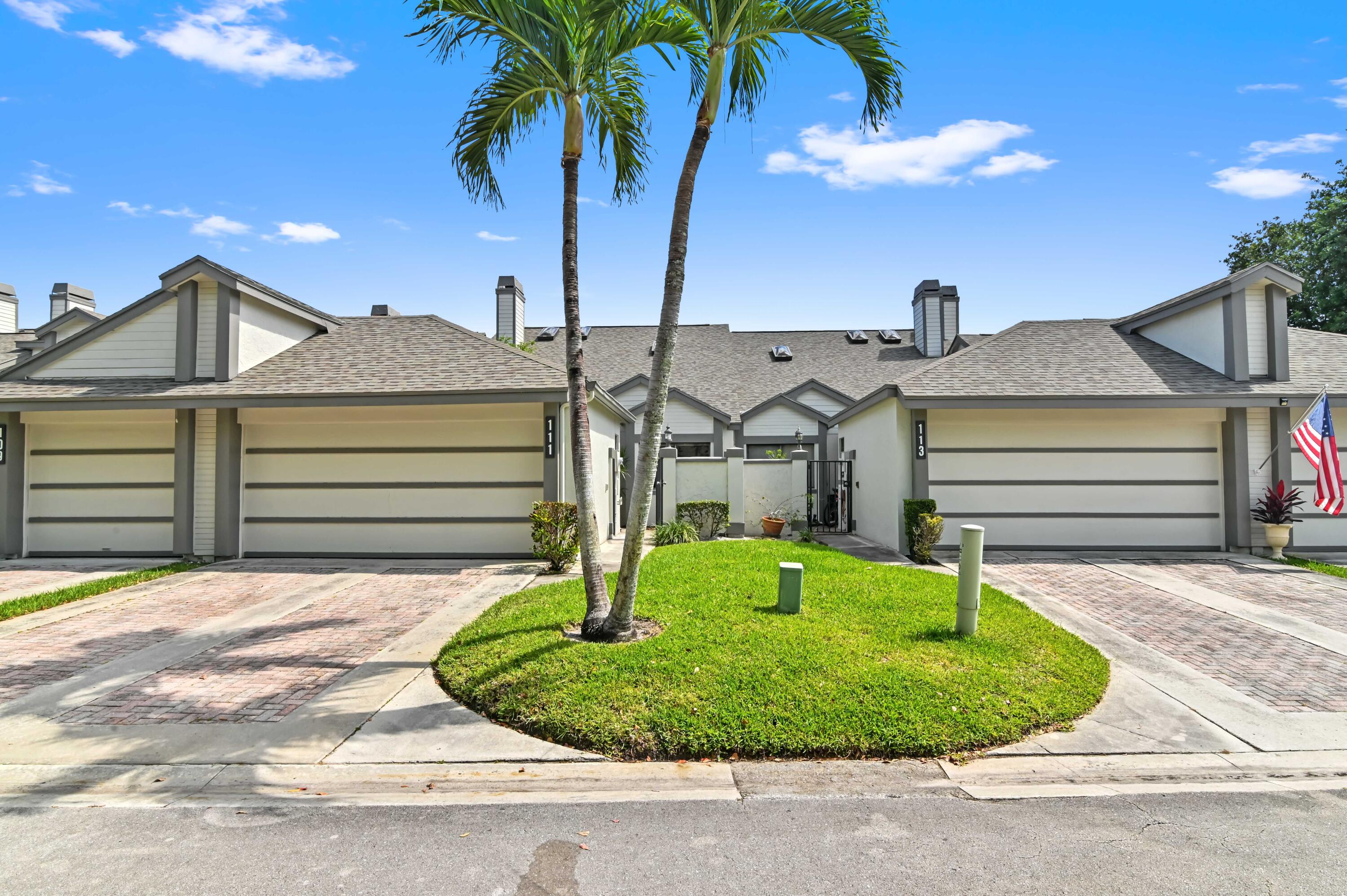 a front view of a house with a yard garage and outdoor seating