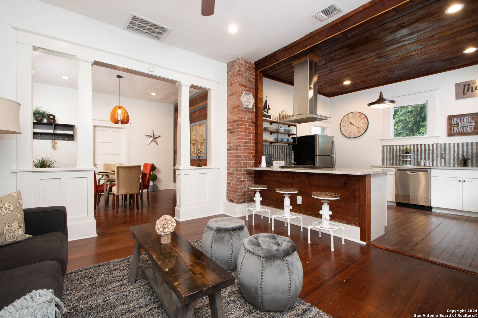 a living room with fireplace furniture and a large window