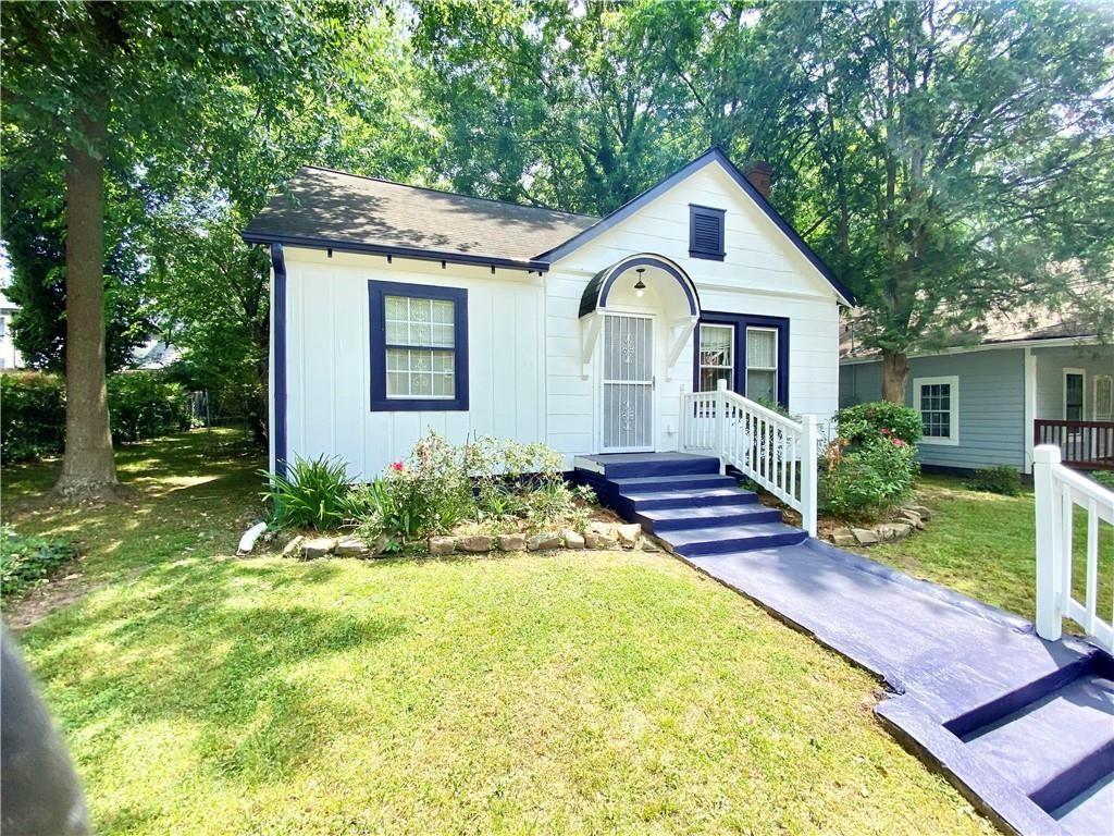 a front view of a house with garden