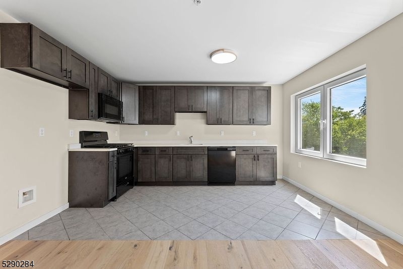 a kitchen with a stove a sink and a refrigerator