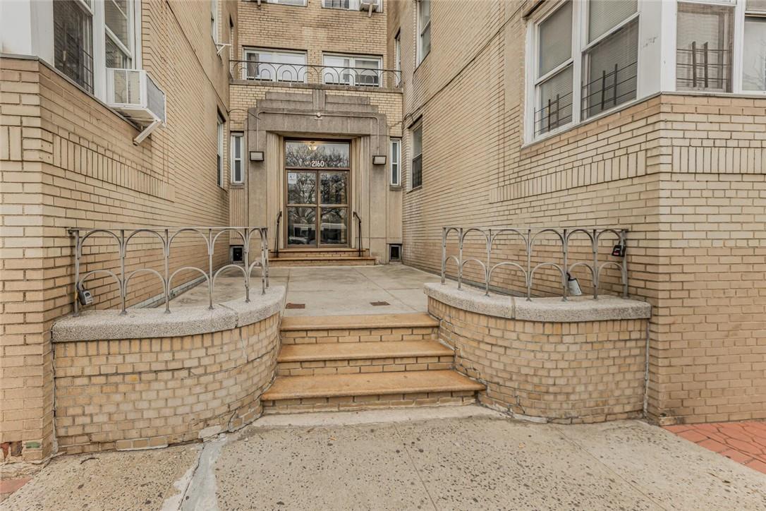 Entrance to property featuring a patio and a balcony