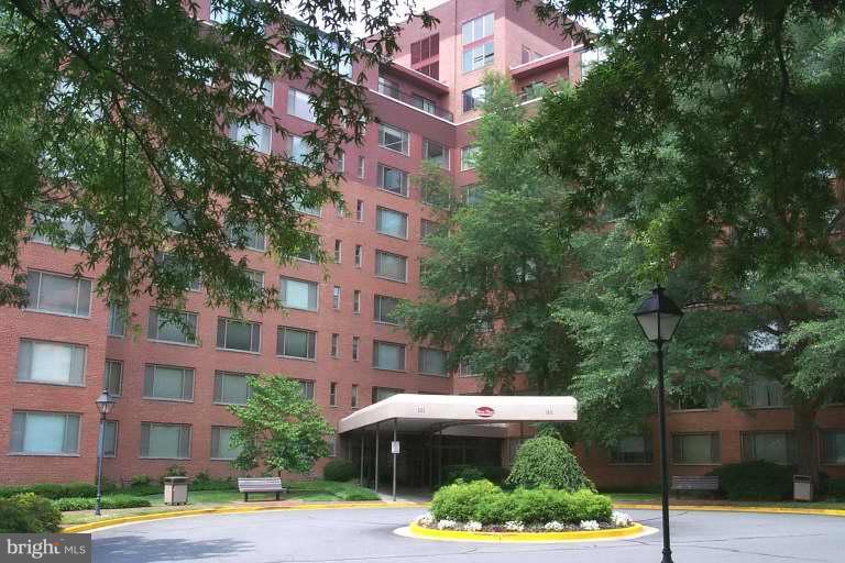 a front view of a multi story building with yard