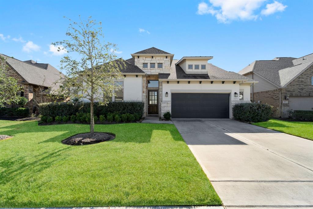 a front view of a house with a yard and a garage