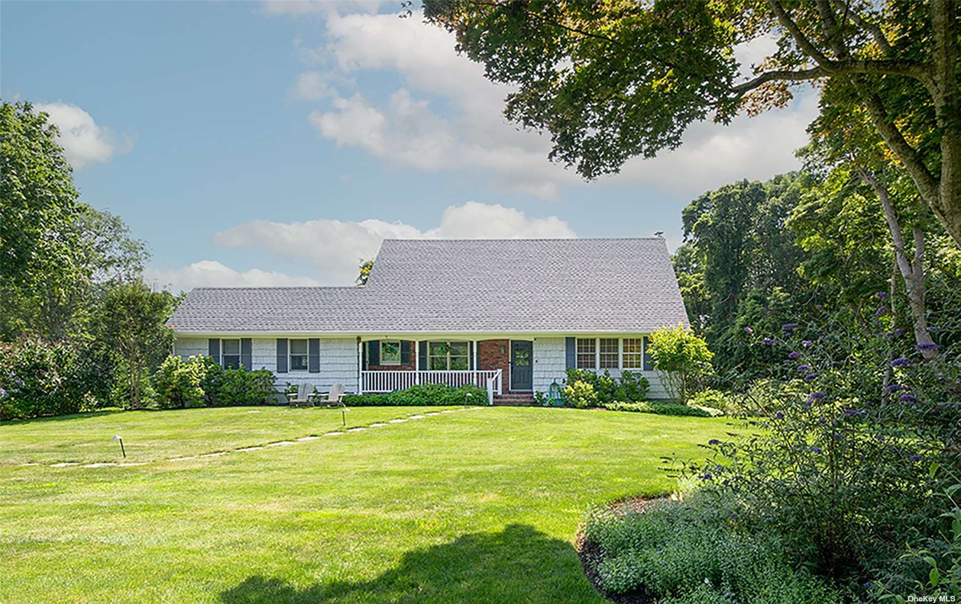 a view of house with a yard