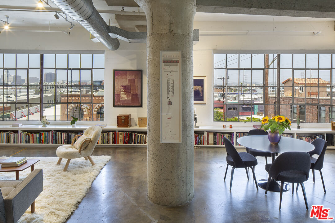 a living room with furniture and a floor to ceiling window