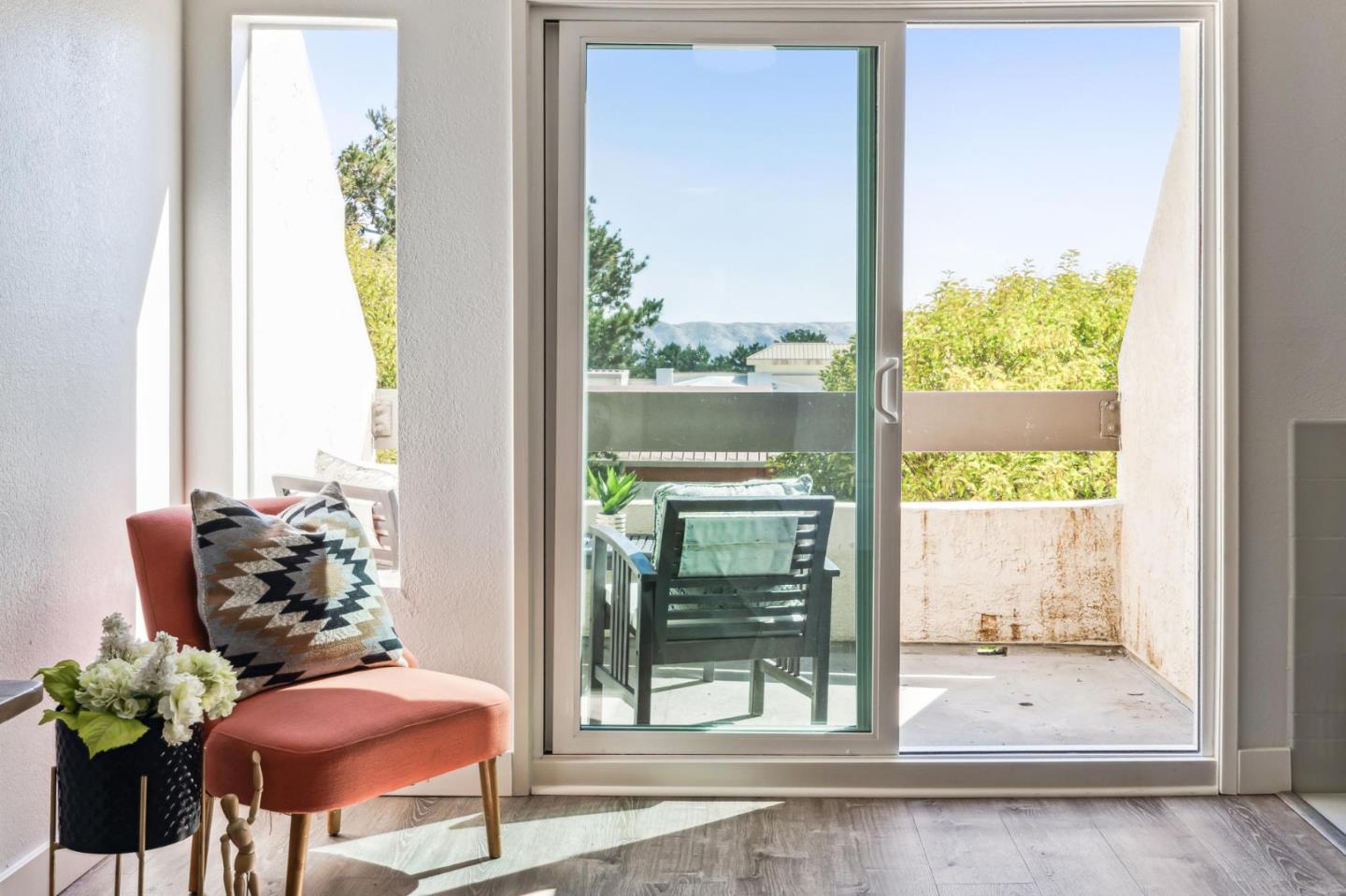 a view of a balcony with chair and table