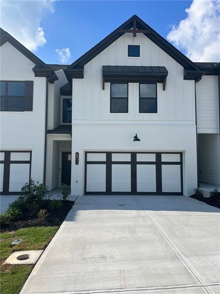 a front view of a house with garage