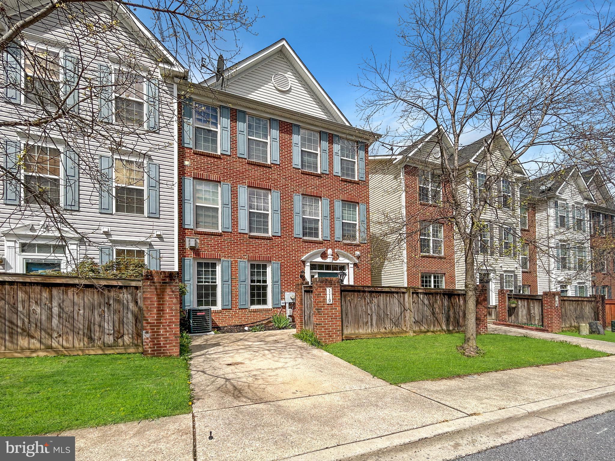 a view of a brick building next to a yard