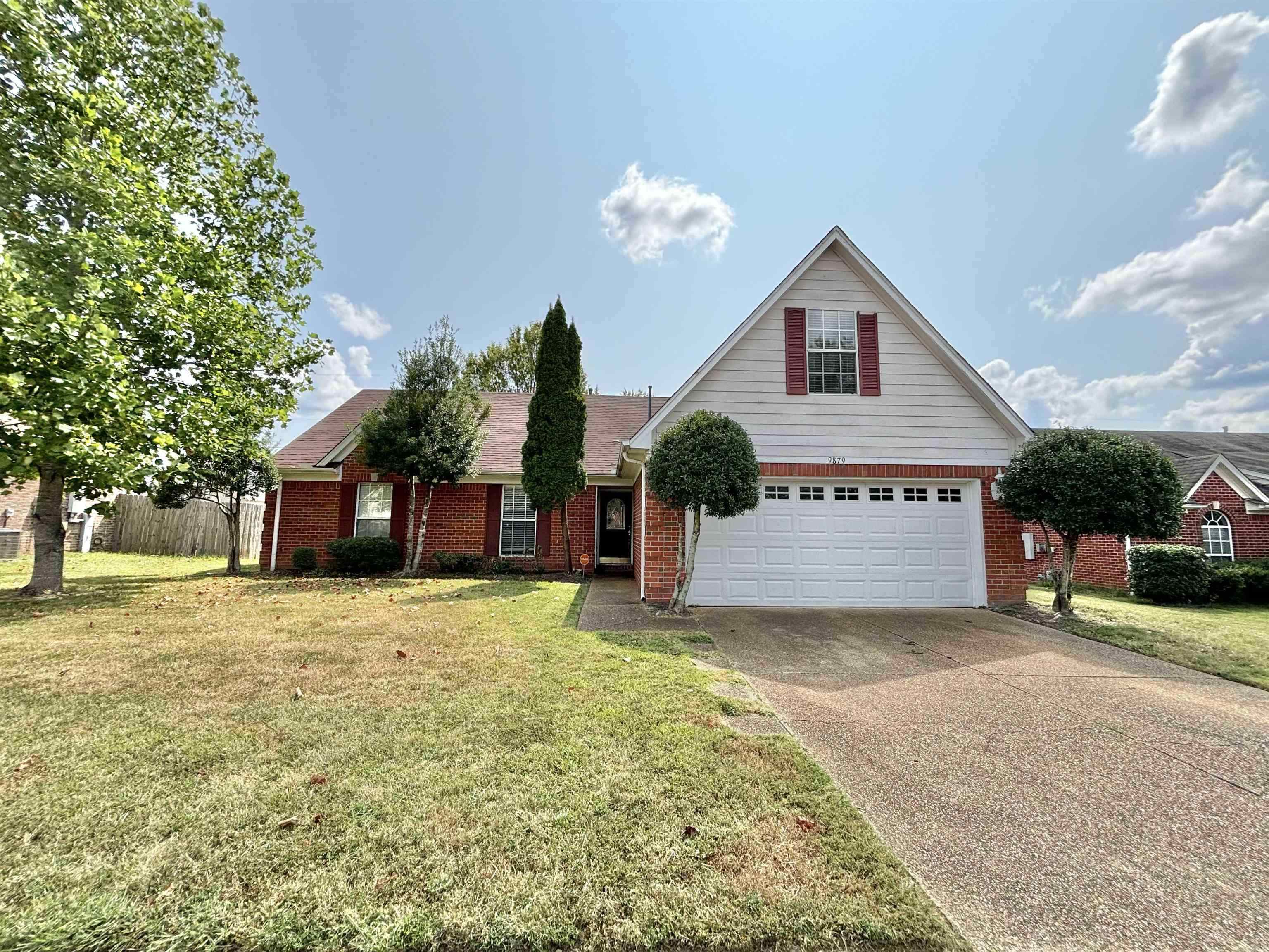 a view of a house with a yard and garage