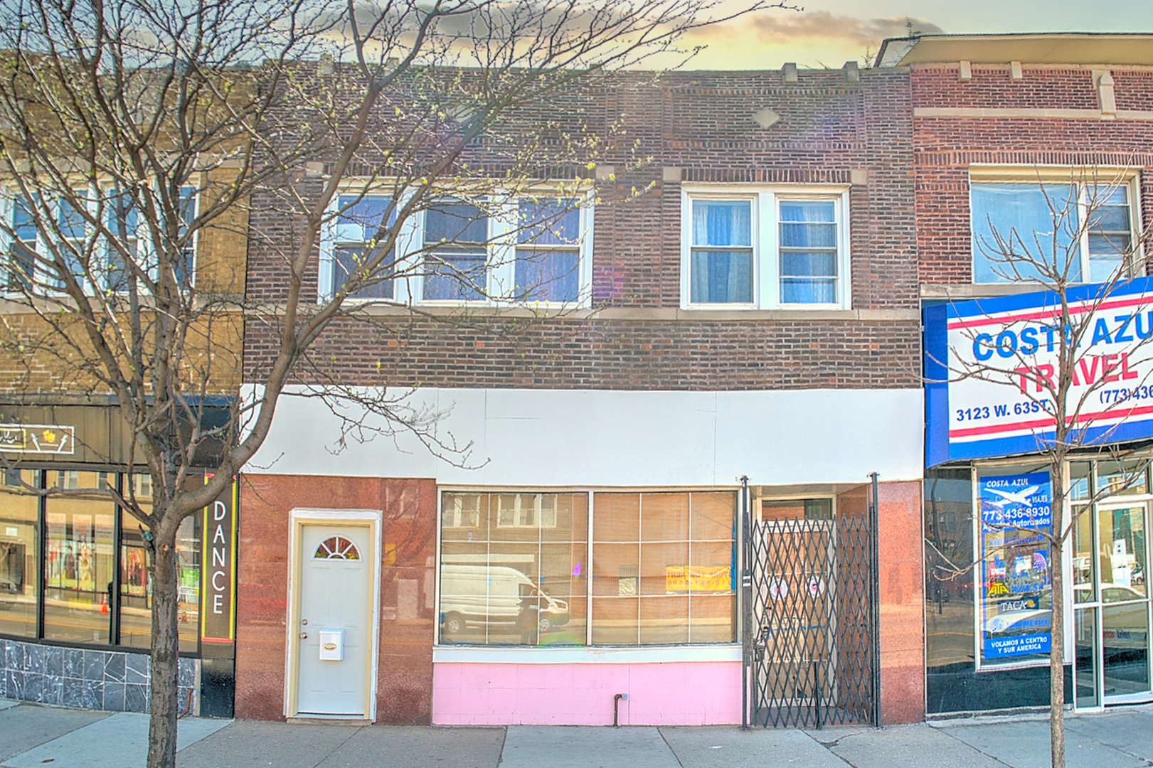 a front view of multi story residential apartment building with yard