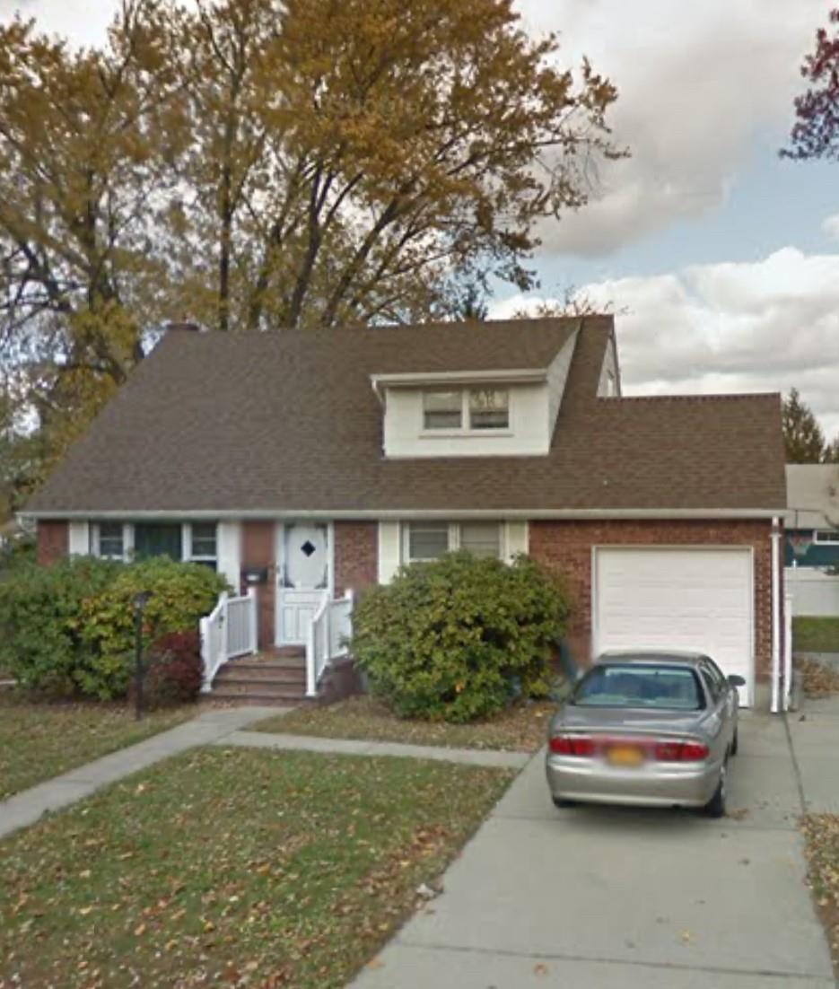 View of front of home featuring a garage and a front yard