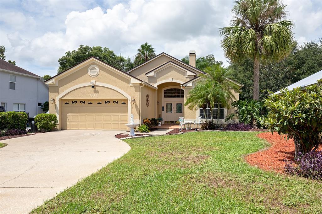 a front view of a house with yard and green space