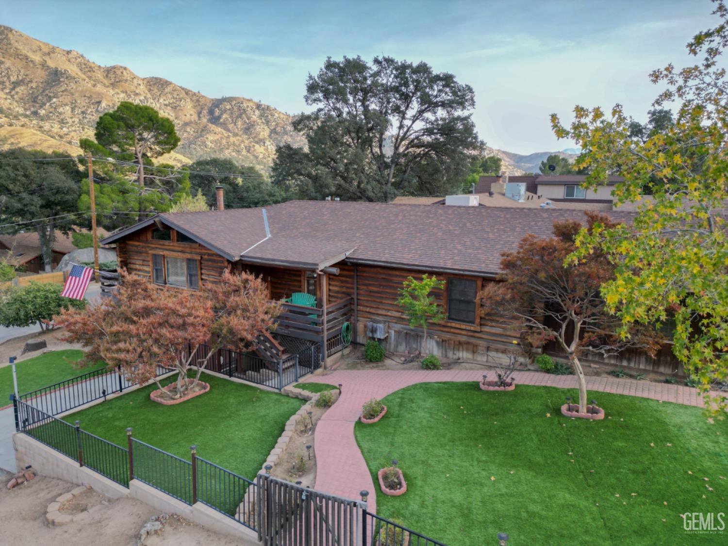 an aerial view of a house with garden space and trees