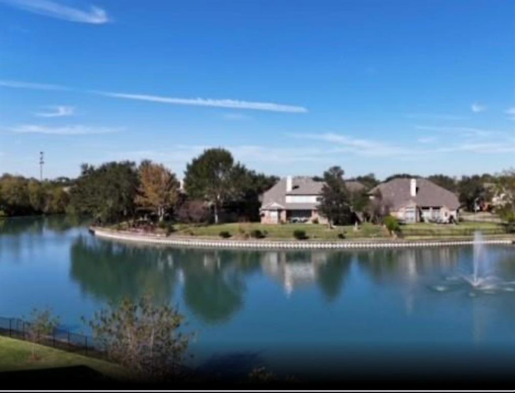 a view of a lake with houses in the back