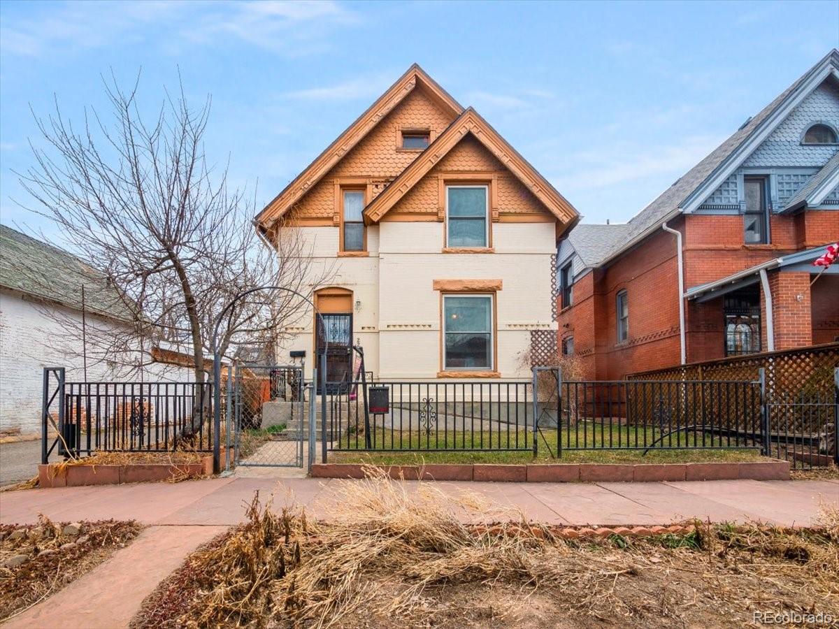 a view of a house with a yard next to a house