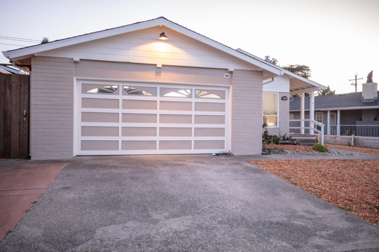 a view of a house with a yard and garage