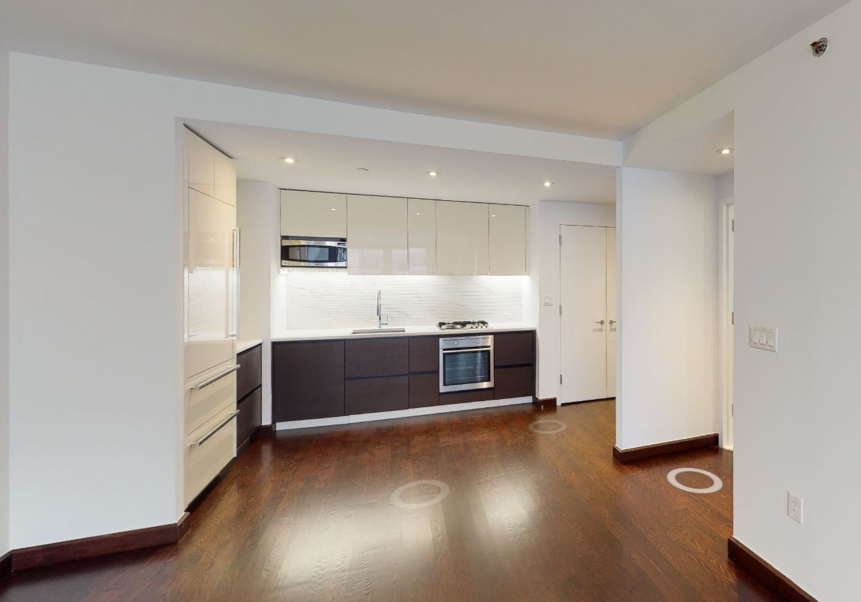 a kitchen with stainless steel appliances a refrigerator and a stove top oven