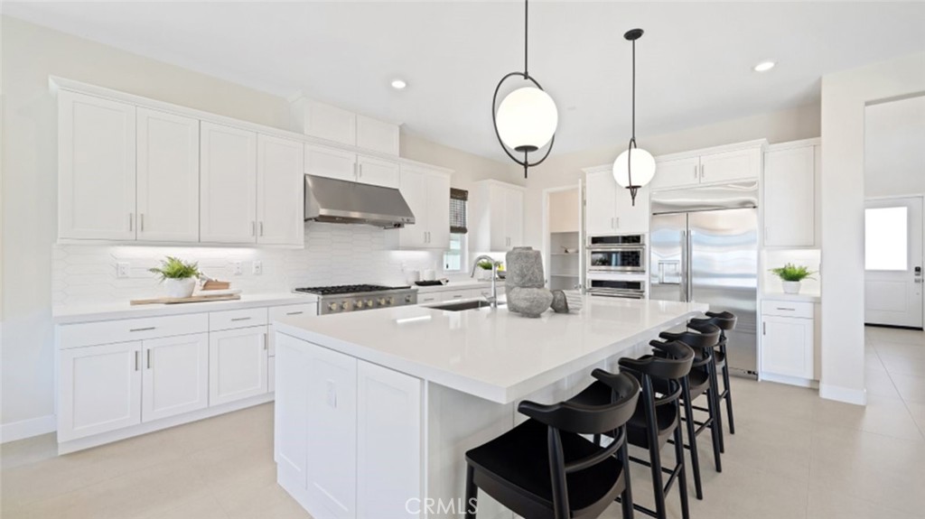 a kitchen with a stove a table and chairs in it