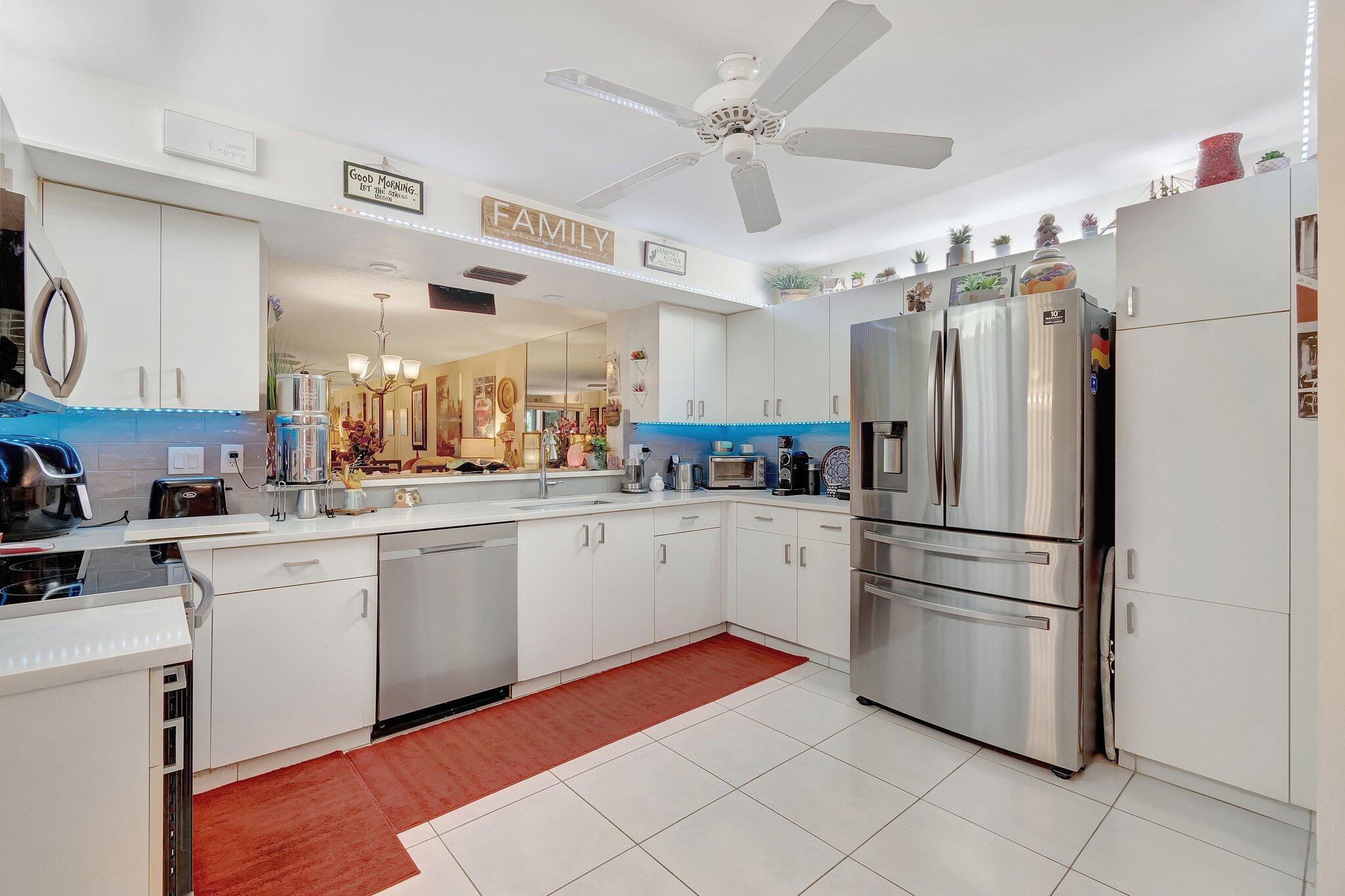 a kitchen with white cabinets and white stainless steel appliances