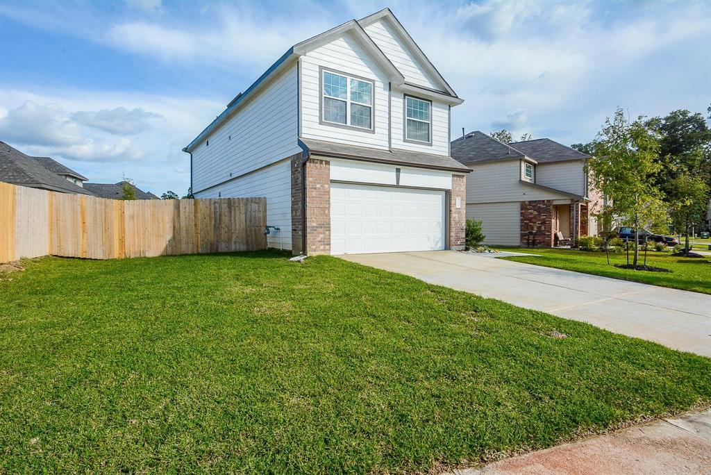 a front view of a house with a garden and yard