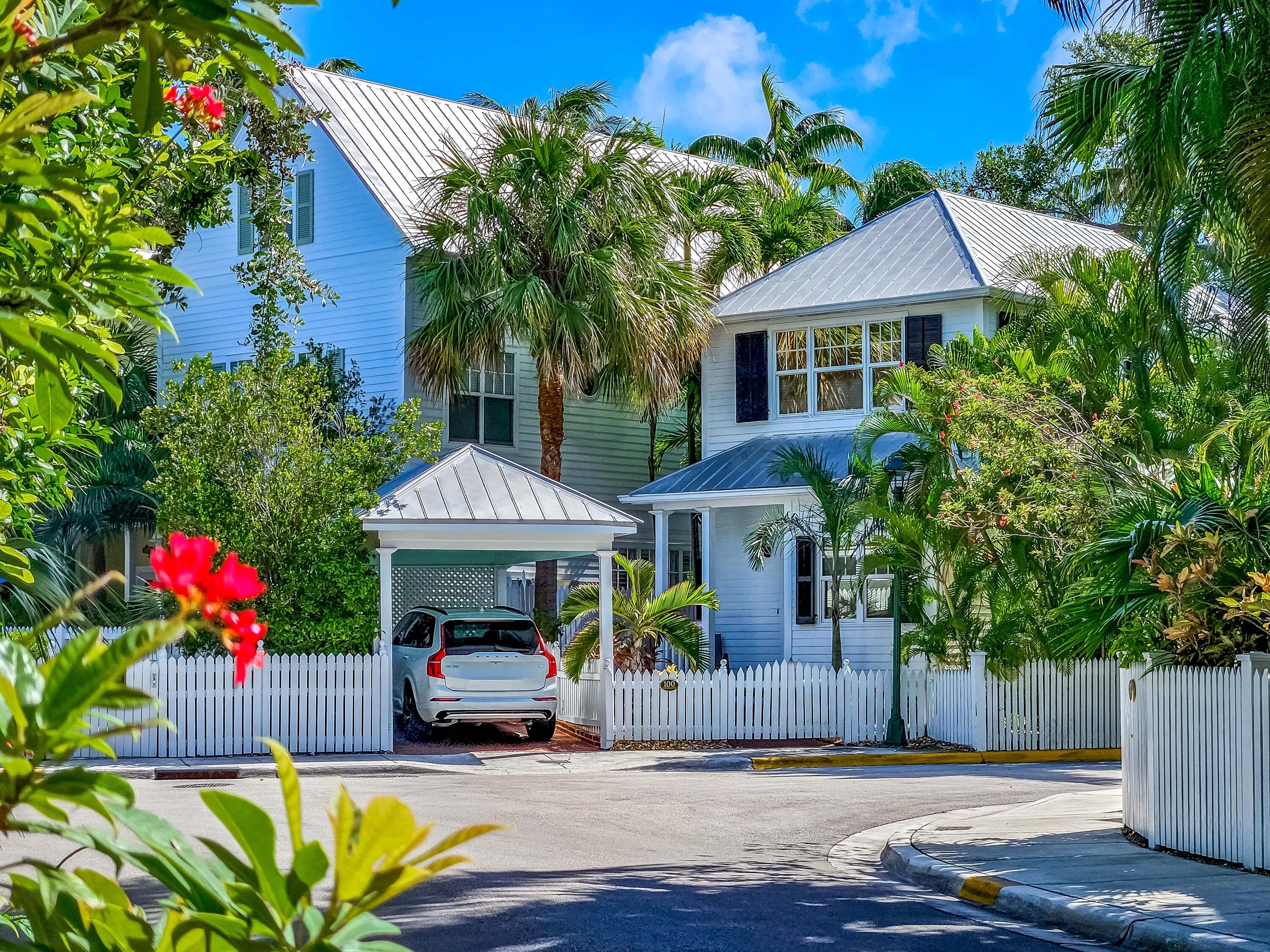 a front view of a house with a yard and a garden