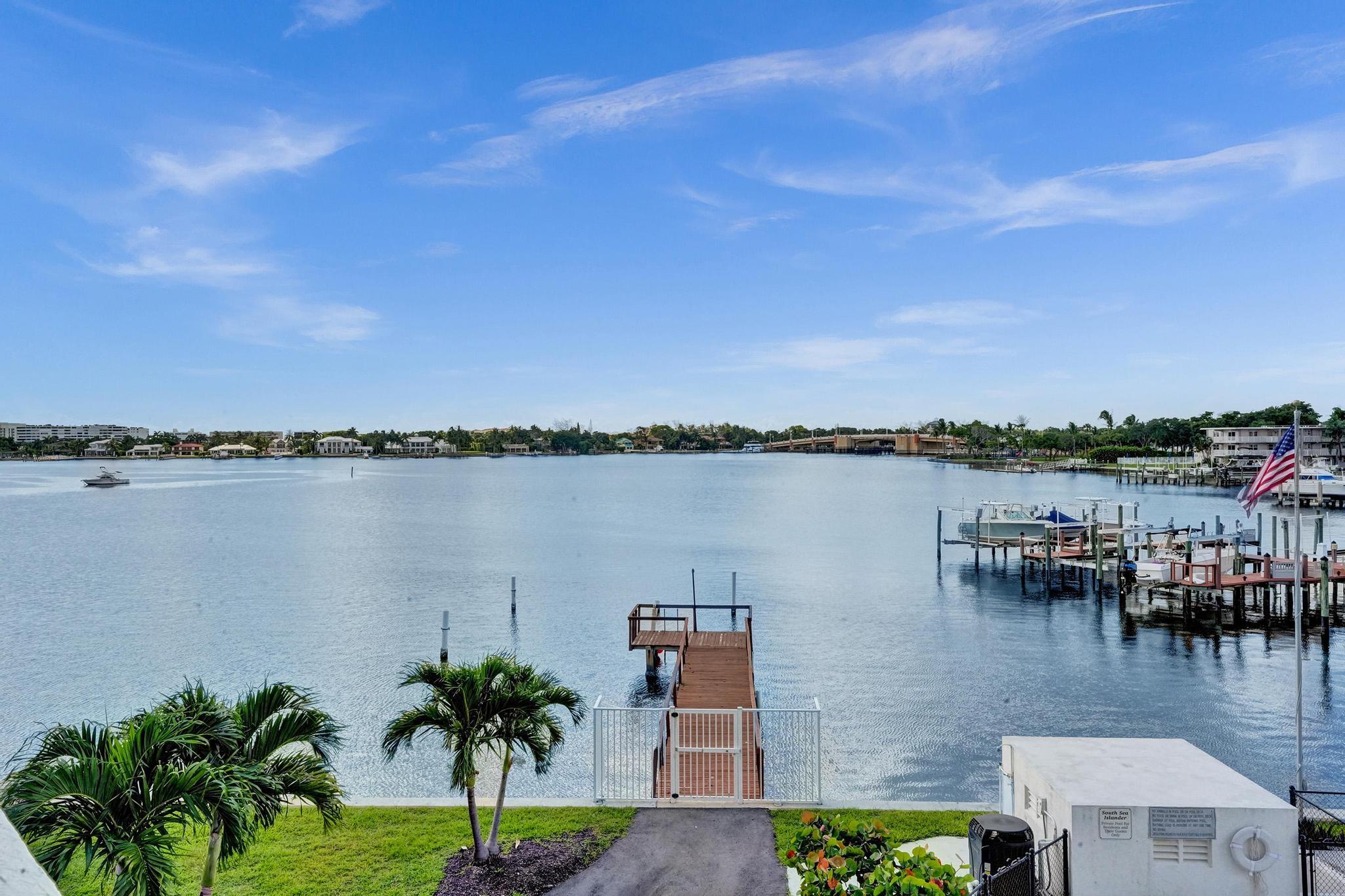 a view of a lake with houses in the back