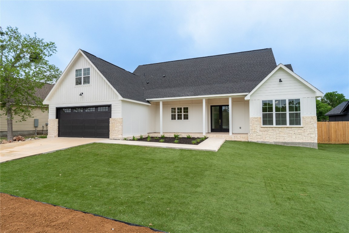 a front view of a house with a garden and yard