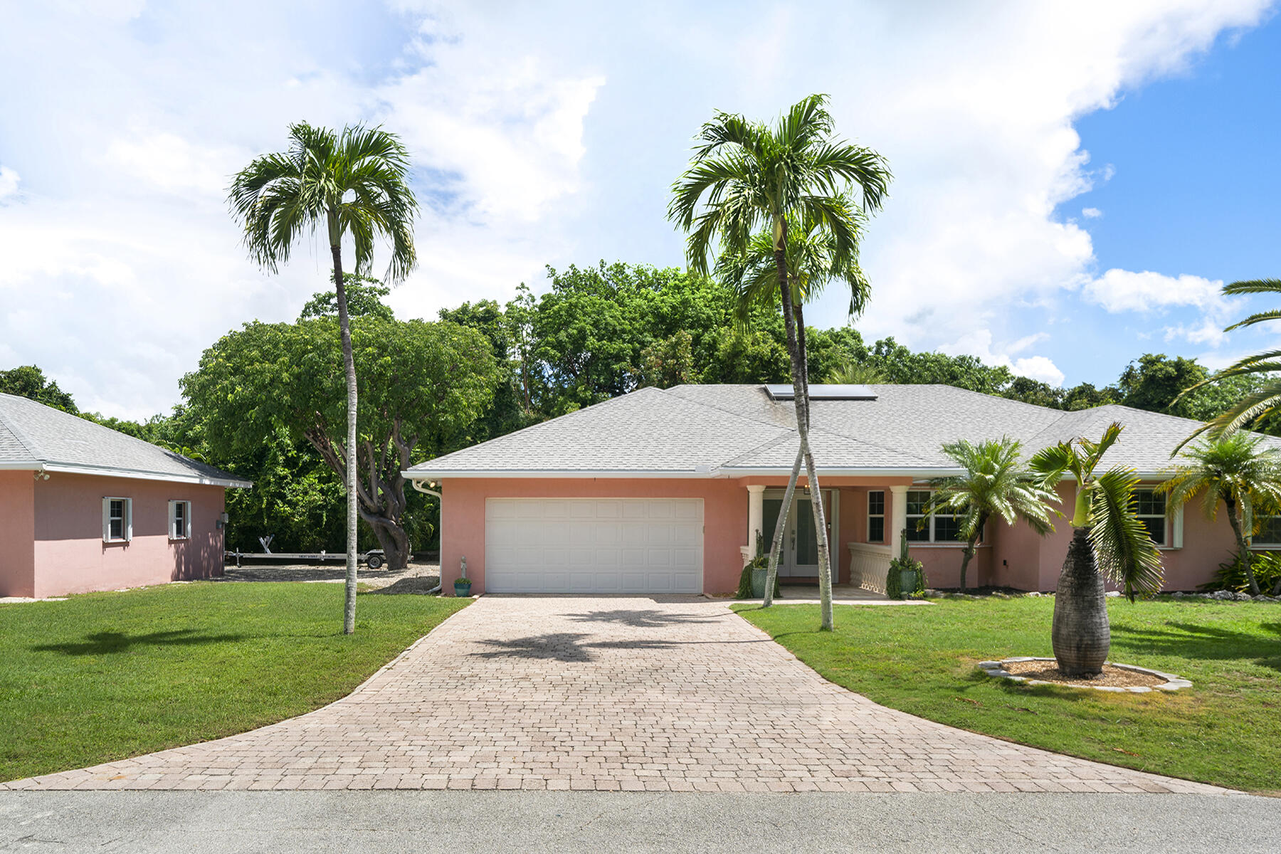 a front view of a house with a garden