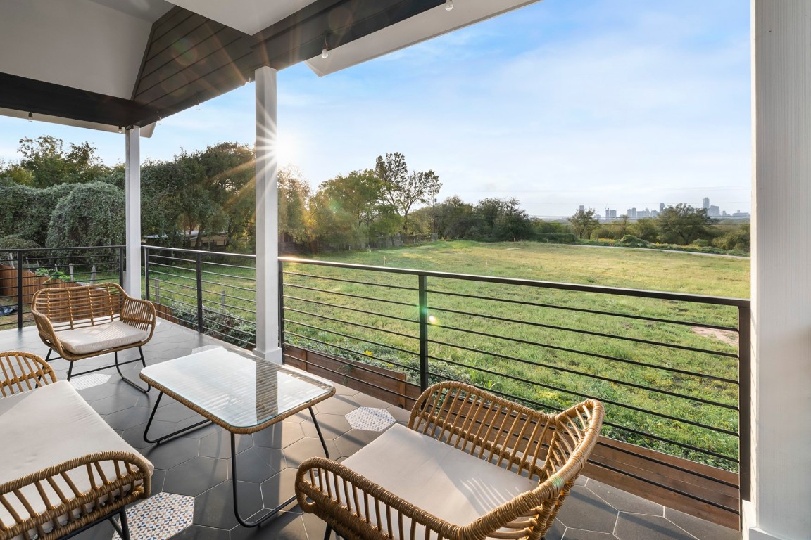 a view of a chairs and table in patio with a lake view