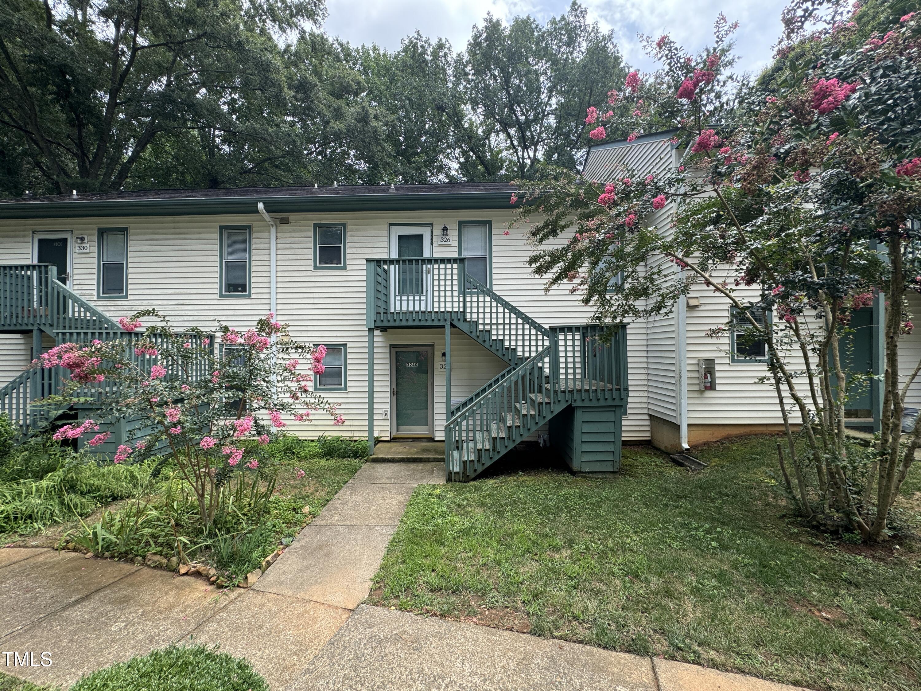 a front view of house with a garden