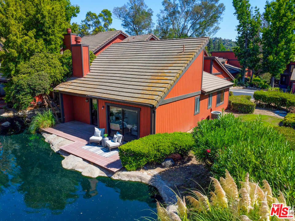 a view of house with backyard and sitting area