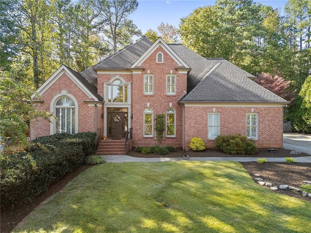 a front view of a house with a yard