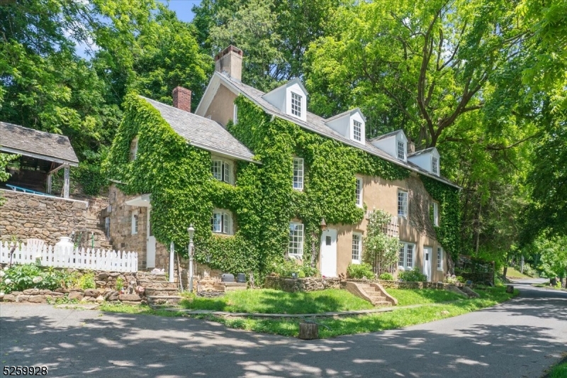 a front view of a house with a yard and trees