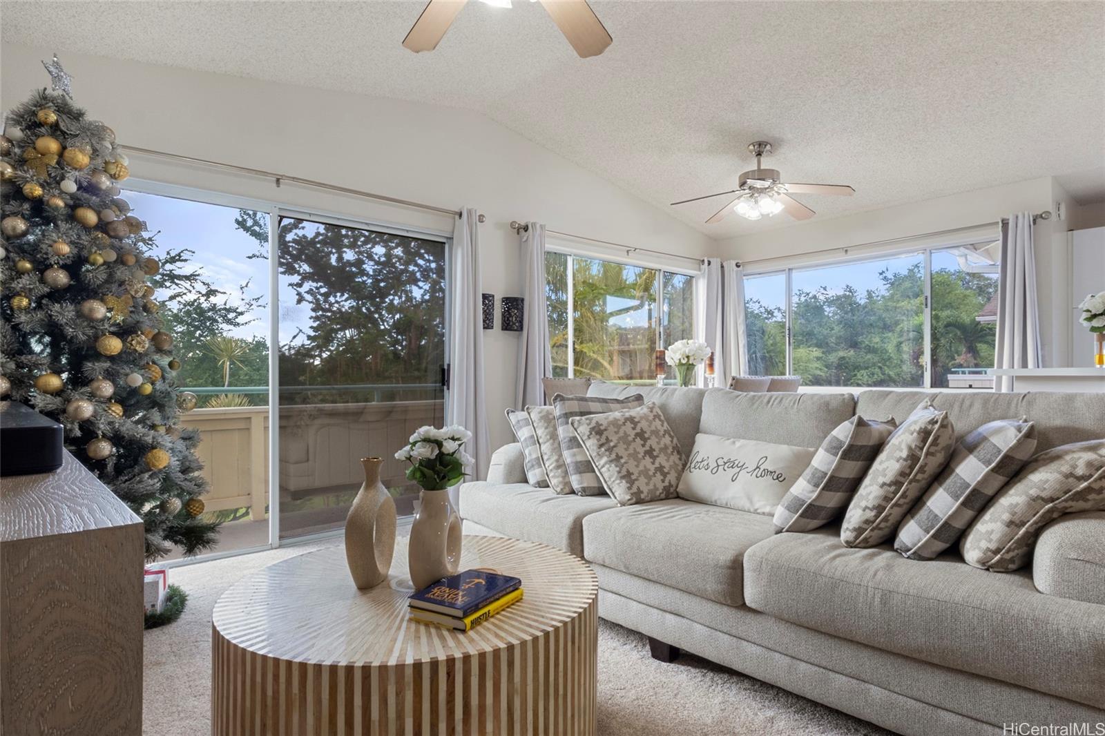 a living room with furniture and a floor to ceiling window