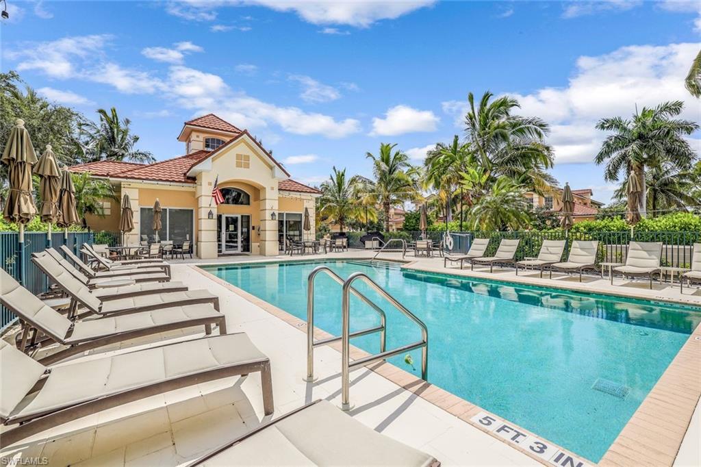 a view of a house with pool and chairs